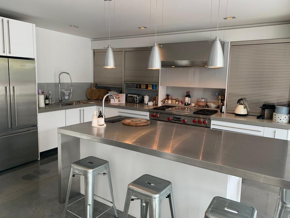 L-Shaped Island Kitchen with Corian Worktops & Wolf Appliances